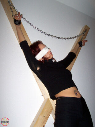 Blinded sandy-haired Lilu Natilova is shackled to a St