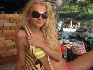 Sumptuous light-haired tiny female wearing uber-sexy bikinis